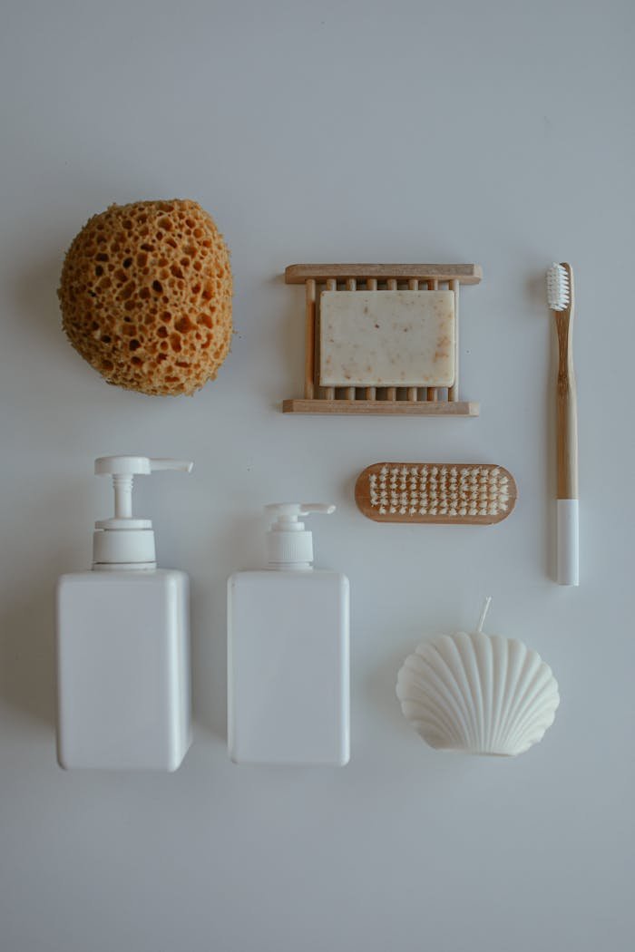 Top view of various eco-friendly personal hygiene items on a neutral backdrop.